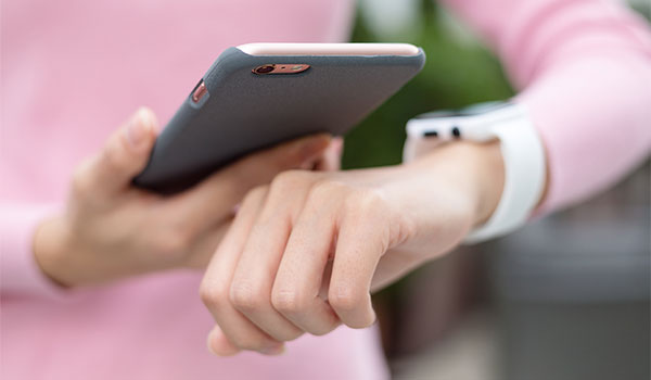 Cellphone next to a smart watch